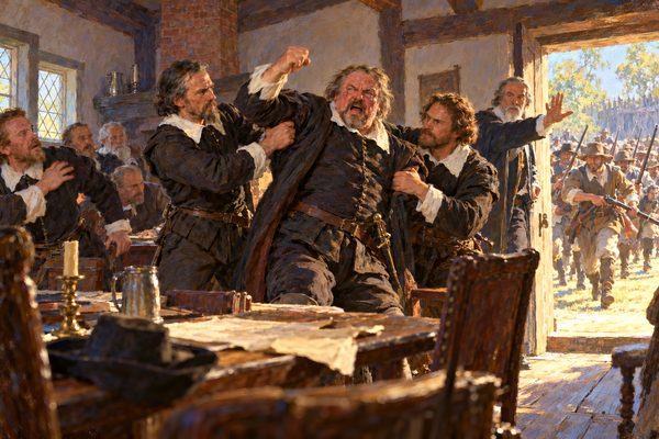 In a timber-beamed room, two men in dark doublets grip the arms of a red-faced, shouting man with a raised fist, while another man stands in a sunlit doorway with his hand up and armed men run toward the house behind him.