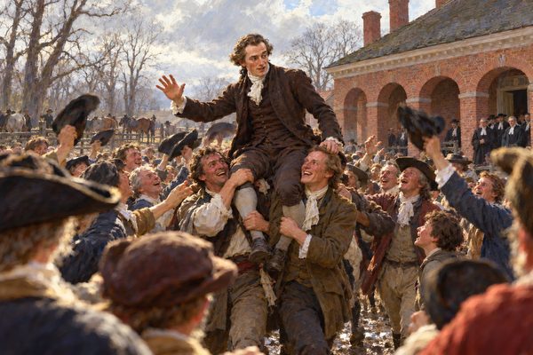 A young man in a dark coat rides high on the shoulders of four men across a muddy yard, one hand raised, as a crowd of farmers and townsmen cheers and waves hats before a brick courthouse with arched doorways.