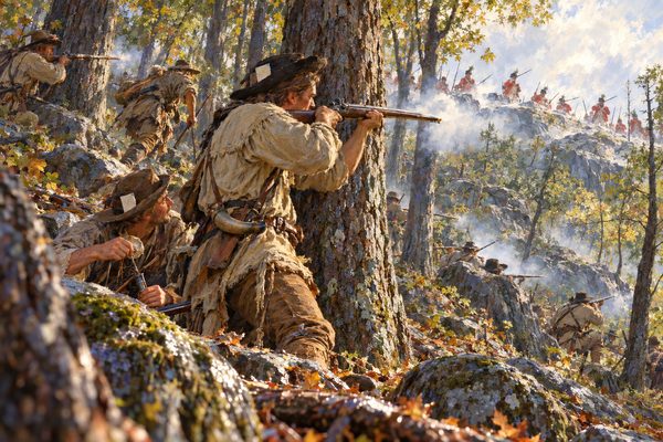 Frontiersmen in hunting shirts climb a wooded, rocky slope, one aiming a long rifle uphill from behind an oak while gunsmoke drifts between the trunks toward red-coated soldiers on the open summit above.