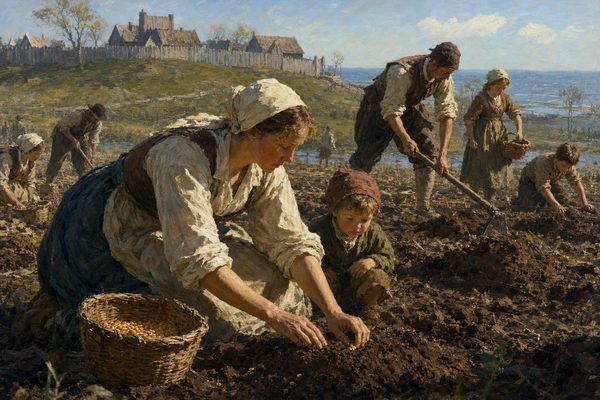 A woman in a white cap and rolled sleeves crouches in freshly turned earth, pressing seed into a mound while a small child watches. Other families work separate plots behind them, below a palisaded hill.